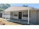 Welcoming entrance to a home, featuring a covered front porch and neat landscaping at 5122 Dove Dr, New Port Richey, FL 34652
