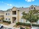 Exterior shot of the condominium featuring beige walls, white trim, and manicured shrubs at 6439 Cypressdale Dr # 101, Riverview, FL 33578
