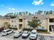 Residential building featuring a parking lot and well-maintained landscaping at 6439 Cypressdale Dr # 101, Riverview, FL 33578