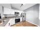 Bright kitchen features stainless steel appliances, granite countertops, and white cabinets at 6439 Cypressdale Dr # 101, Riverview, FL 33578