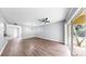 Open living room with sliding glass doors to screened patio and view of kitchen at 6439 Cypressdale Dr # 101, Riverview, FL 33578
