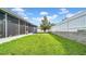 Fenced-in backyard with lush lawn and a tree at 650 Arbor Ln, Largo, FL 33770