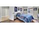 Bedroom with sports-themed décor and blue bedding, complete with hardwood flooring at 650 Arbor Ln, Largo, FL 33770