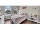 Bedroom with arched windows and natural light features stylish decor and hardwood flooring at 650 Arbor Ln, Largo, FL 33770