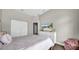 Well-lit bedroom featuring a dresser with a flat screen TV and hardwood flooring at 650 Arbor Ln, Largo, FL 33770