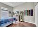This bedroom has sports memorabilia, wood floors and a large window at 650 Arbor Ln, Largo, FL 33770