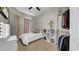 Bright bedroom featuring a queen bed, walk-in closet and dressing mirror at 650 Arbor Ln, Largo, FL 33770