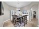 Cozy dining area featuring a wooden table with chairs and a stylish light fixture at 650 Arbor Ln, Largo, FL 33770