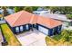Charming single-story home featuring an attached garage and manicured front yard landscaping at 650 Arbor Ln, Largo, FL 33770