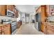 Long kitchen features stainless steel appliances, wood cabinetry, and ample counter space at 650 Arbor Ln, Largo, FL 33770