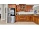 Well-equipped kitchen featuring stainless steel refrigerator and beautiful wood cabinetry at 650 Arbor Ln, Largo, FL 33770