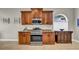 Functional kitchen area equipped with stainless steel appliances and wood cabinetry at 650 Arbor Ln, Largo, FL 33770