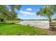 Serene lake view from the park with lush greenery and a clear blue sky at 650 Arbor Ln, Largo, FL 33770
