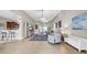 Inviting living area with tile flooring, offering a view of the kitchen and front entryway at 650 Arbor Ln, Largo, FL 33770