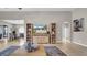 Bright living space with tile floors, decorative shelving, and a view into the dining area at 650 Arbor Ln, Largo, FL 33770