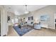 Bright living room with tile floors, ceiling fan, and neutral-toned furniture and decor at 650 Arbor Ln, Largo, FL 33770
