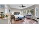 Bright main bedroom with hardwood floors, a ceiling fan, and ample natural light at 650 Arbor Ln, Largo, FL 33770