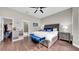 Comfortable main bedroom featuring a ceiling fan, a stylish accent bench and two rustic nightstands at 650 Arbor Ln, Largo, FL 33770