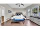 Airy main bedroom featuring a king bed, modern furniture, and hardwood floors at 650 Arbor Ln, Largo, FL 33770