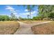 Scenic park pathway leads to playground and picnic shelter on a sunny day at 650 Arbor Ln, Largo, FL 33770