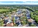 Aerial view of homes surrounded by trees and a lake with blue skies above at 6526 Summer Cove Dr, Riverview, FL 33578