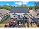 Aerial view of a home with a spacious backyard, including a play area and a patio at 6526 Summer Cove Dr, Riverview, FL 33578
