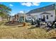 Spacious backyard featuring an outdoor seating, a playground, and a fire pit area at 6526 Summer Cove Dr, Riverview, FL 33578