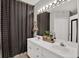 Bathroom boasts double sinks, vanity, patterned shower curtain and great lighting at 6526 Summer Cove Dr, Riverview, FL 33578