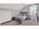 Serene bedroom with soft gray tones, featuring a plush bed and dresser at 6526 Summer Cove Dr, Riverview, FL 33578