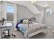 Bright bedroom with desk area, sloped ceilings, and natural light from large windows at 6526 Summer Cove Dr, Riverview, FL 33578