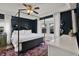Charming bedroom with a four-poster bed, ceiling fan, and bright bay window at 6526 Summer Cove Dr, Riverview, FL 33578