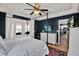 Beautiful bedroom features a four-poster bed, ceiling fan, and convenient TV at 6526 Summer Cove Dr, Riverview, FL 33578