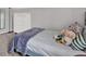 Comfortable bedroom with plush bedding, a large dresser, and soft natural lighting at 6526 Summer Cove Dr, Riverview, FL 33578