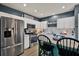Well-lit kitchen features stainless steel appliances and a breakfast bar with bar stool seating at 6526 Summer Cove Dr, Riverview, FL 33578