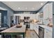Modern kitchen with white cabinets, stainless steel appliances, and a butcher block island with bar stools at 6526 Summer Cove Dr, Riverview, FL 33578