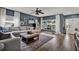 Spacious living room with hardwood floors, a ceiling fan, and natural light from a large window at 6526 Summer Cove Dr, Riverview, FL 33578