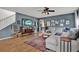 Bright living room featuring wood floors, a ceiling fan, with cozy furniture and a stylish rug at 6526 Summer Cove Dr, Riverview, FL 33578