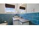 Bright bathroom features a modern vanity with granite countertop and tile walls at 6700 Sunset Way # 206, St Pete Beach, FL 33706