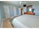 Bedroom with doors, a dresser, a TV and a ceiling fan at 6700 Sunset Way # 206, St Pete Beach, FL 33706