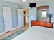 Coastal bedroom features light blue walls, a ceiling fan, dresser, a view, and two closets at 6700 Sunset Way # 206, St Pete Beach, FL 33706