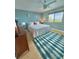 Light and airy bedroom featuring a ceiling fan, bright window, and coastal-themed decor at 6700 Sunset Way # 206, St Pete Beach, FL 33706