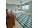 Comfortable bedroom with beach-themed decor, a queen-sized bed, and plenty of natural light at 6700 Sunset Way # 206, St Pete Beach, FL 33706