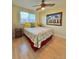 Well-lit bedroom with beach-themed decor, ceiling fan and light wood floors at 6700 Sunset Way # 206, St Pete Beach, FL 33706