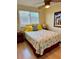 Cozy bedroom featuring a ceiling fan, colorful decor, and light wood floors at 6700 Sunset Way # 206, St Pete Beach, FL 33706