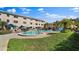 Outdoor pool with tanning chairs and green landscaping for a relaxed community feel at 6700 Sunset Way # 206, St Pete Beach, FL 33706