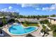 Elevated view of an outdoor community pool with beach views across the street at 6700 Sunset Way # 206, St Pete Beach, FL 33706
