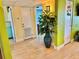 Bright hallway featuring lots of doorways, light wood floors, and a decorative plant at 6700 Sunset Way # 206, St Pete Beach, FL 33706