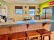 Bright kitchen features stainless steel appliances, bar seating and decor with a beach theme at 6700 Sunset Way # 206, St Pete Beach, FL 33706