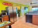 Bright kitchen featuring stainless steel appliances, wood cabinets, and a view into the living area at 6700 Sunset Way # 206, St Pete Beach, FL 33706