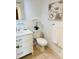 Clean bathroom features a white vanity, a decorative painting, and modern fixtures at 701 S Madison Ave # 414, Clearwater, FL 33756